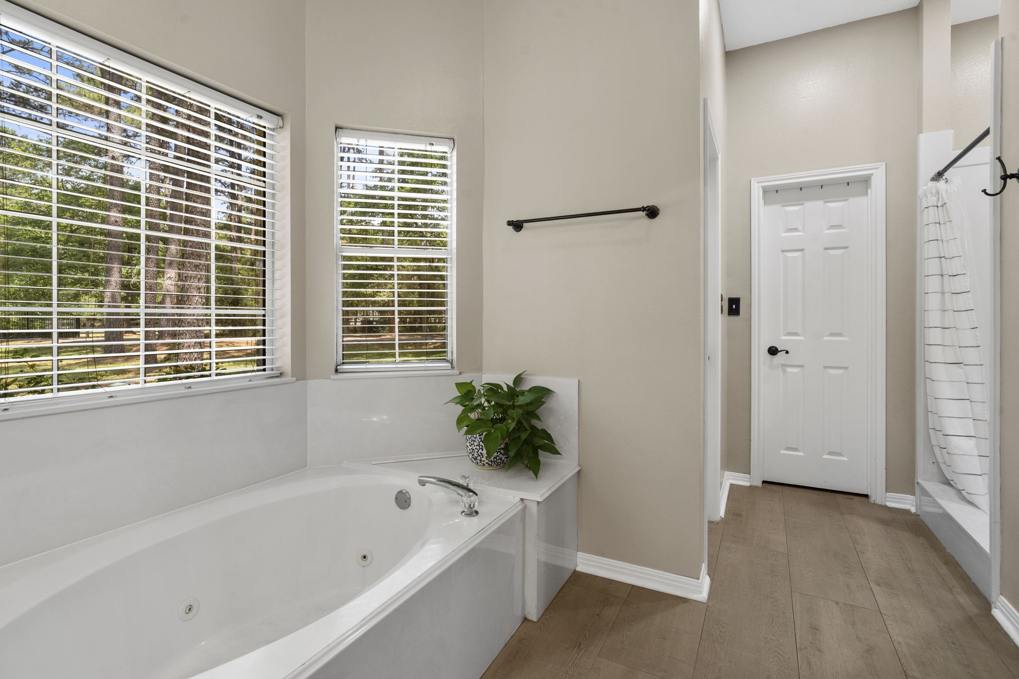 19610 Timber Ridge Drive Magnolia, TX 77355 - Photo 26 of 50 Imagine relaxing in the primary bath, where a jetted tub invites you to soak away the day while a separate walk-in shower adds a sleek, refreshing touch to your own private spa-like escape. A second spacious walk-in closet provides effortless organization and convenient access to your wardrobe. There's a private toilet room just to the left of the shower.