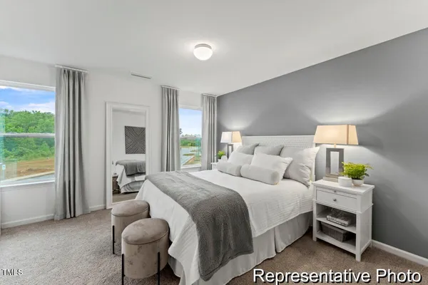 a bedroom with a bed and a large window