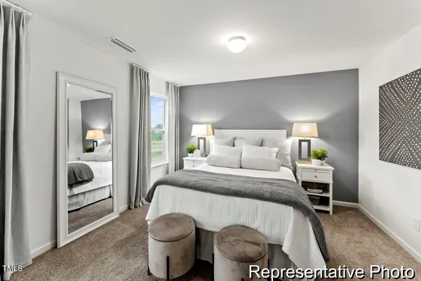 a bedroom with a bed and a view of en suite bathroom