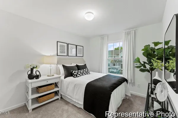 a bedroom with a bed and a potted plant