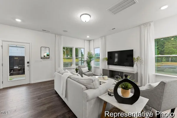 a living room with furniture and a flat screen tv