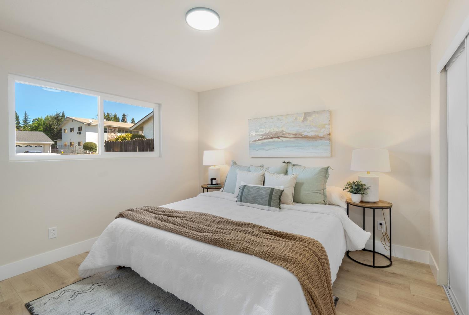 1902 Wildwood Way Roseville, CA 95661 - Photo 12 of 22 a bedroom with a bed and a painting on the wall