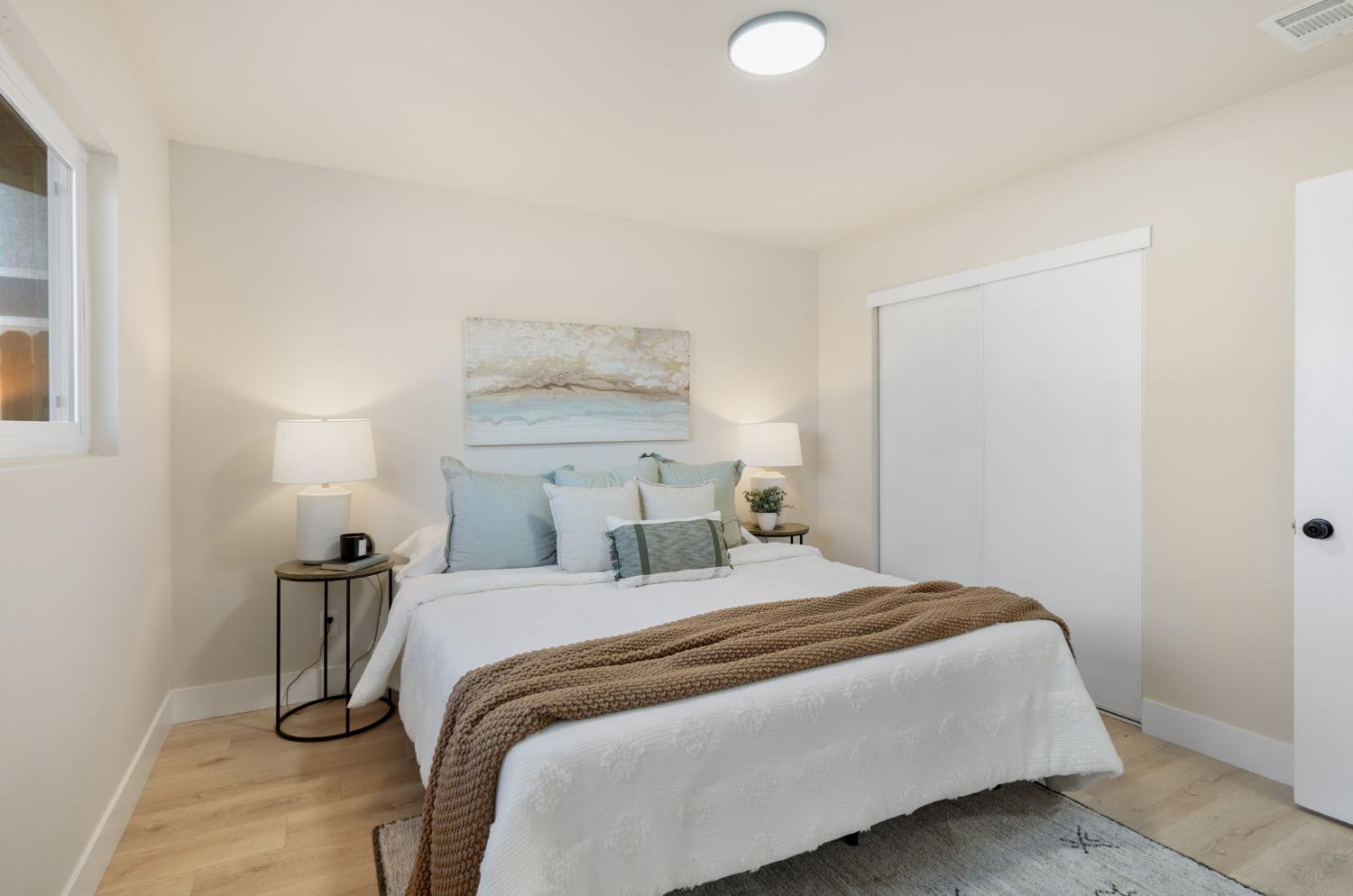 1902 Wildwood Way Roseville, CA 95661 - Photo 13 of 22 a bedroom with a bed and a lamp