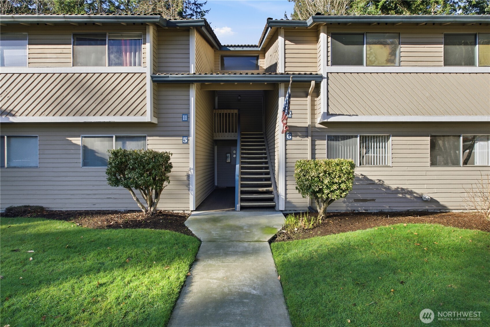 17527 149th Avenue Southeast, Unit B12 Renton, WA 98058 - Photo 1 of 27 a front view of a house with garden
