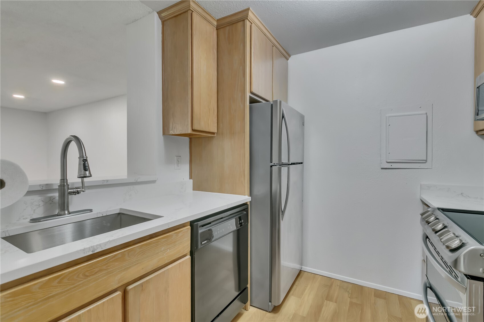17527 149th Avenue Southeast, Unit B12 Renton, WA 98058 - Photo 12 of 27 a kitchen with stainless steel appliances a refrigerator and a sink