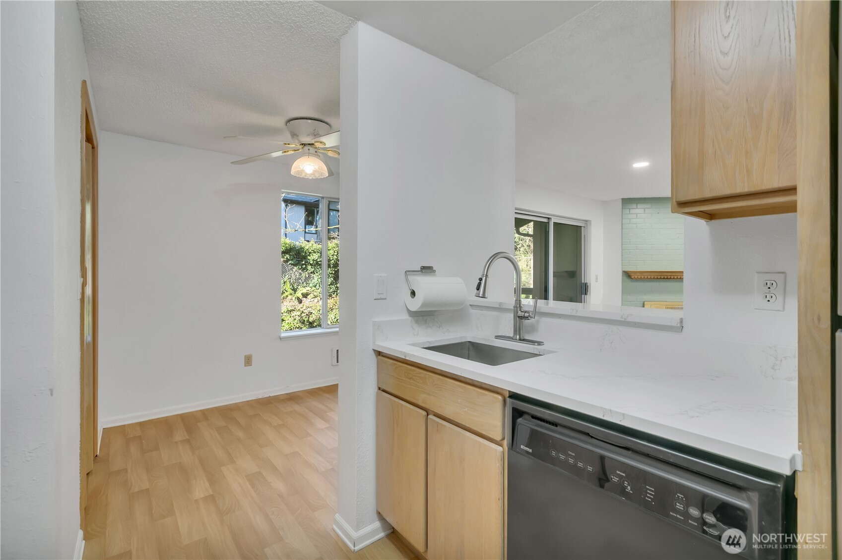 17527 149th Avenue Southeast, Unit B12 Renton, WA 98058 - Photo 14 of 27 a kitchen with a sink and cabinets