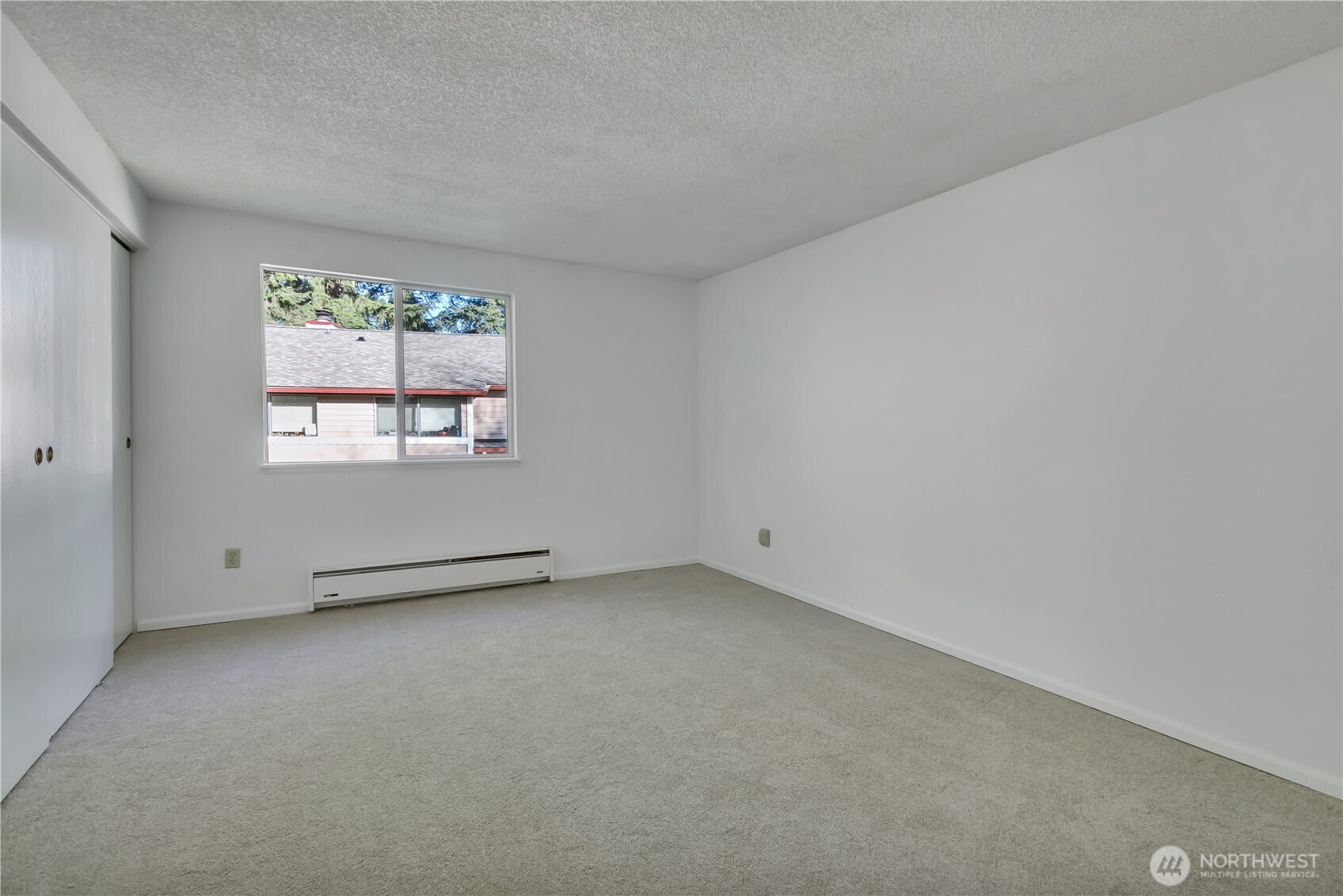17527 149th Avenue Southeast, Unit B12 Renton, WA 98058 - Photo 16 of 27 an empty room with windows