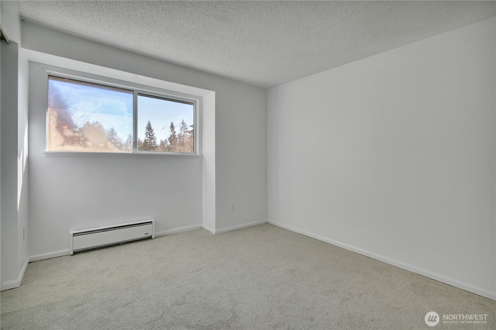 17527 149th Avenue Southeast, Unit B12 Renton, WA 98058 - Photo 22 of 27 an empty room with a window
