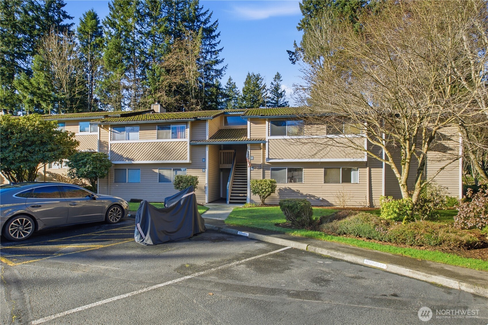17527 149th Avenue Southeast, Unit B12 Renton, WA 98058 - Photo 3 of 27 a view of a car park in front of a house