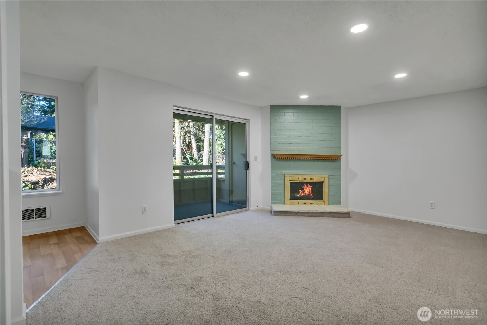 17527 149th Avenue Southeast, Unit B12 Renton, WA 98058 - Photo 6 of 27 an empty room with windows and fireplace