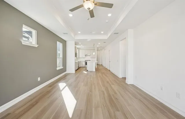 a view of kitchen and hall with wooden floor
