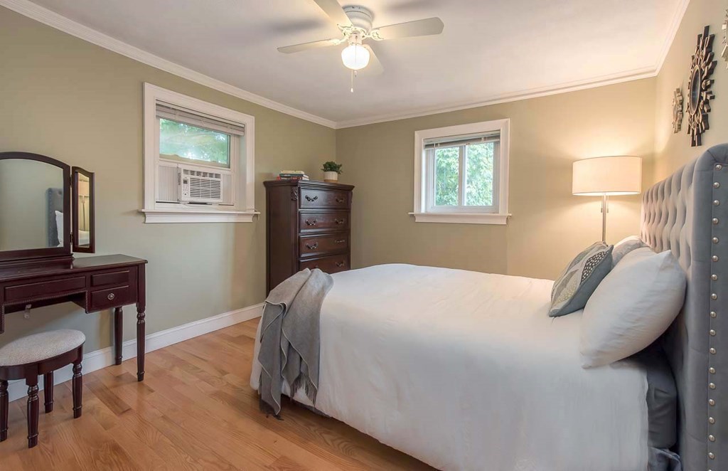 62 Bryon Road, Unit 6 Boston, MA 02467 - Photo 11 of 23 a bedroom with a bed and a chandelier