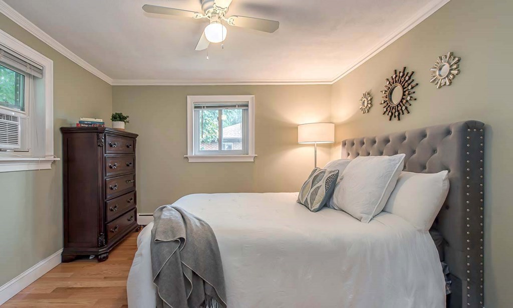 62 Bryon Road, Unit 6 Boston, MA 02467 - Photo 13 of 23 a bedroom with a bed and wooden floor