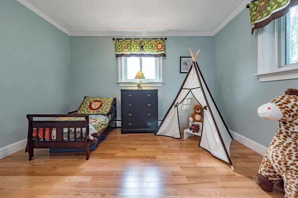 62 Bryon Road, Unit 6 Boston, MA 02467 - Photo 17 of 23 a bedroom with furniture and a window
