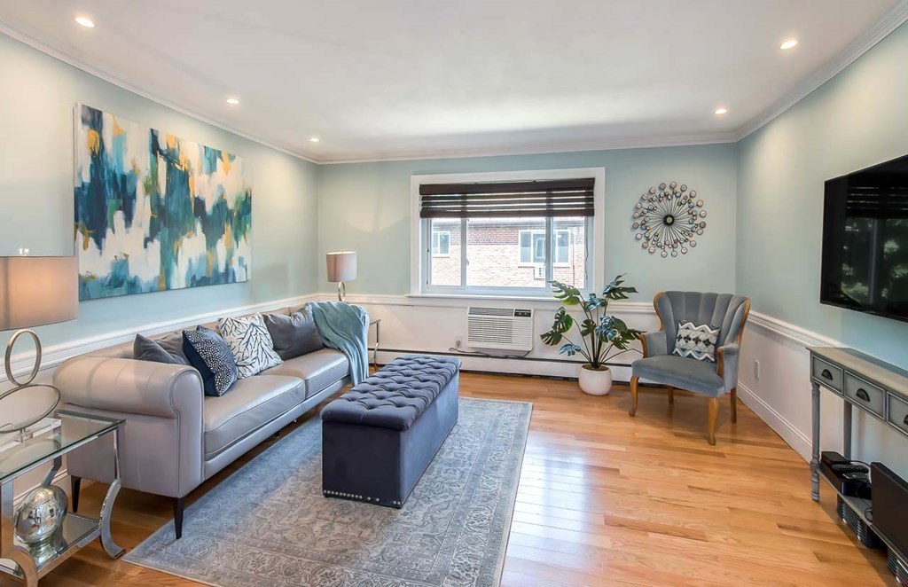 62 Bryon Road, Unit 6 Boston, MA 02467 - Photo 2 of 23 a living room with furniture and a flat screen tv