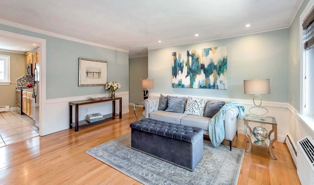 62 Bryon Road, Unit 6 Boston, MA 02467 - Photo 3 of 23 a living room with furniture and a wooden floor