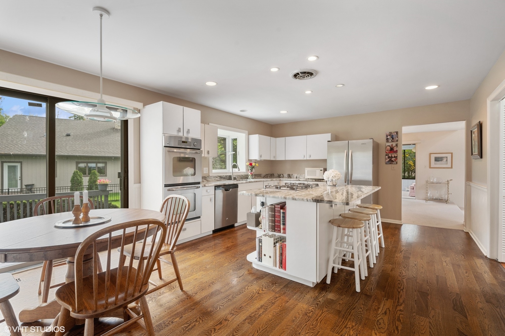 63 Overlook Drive Golf, IL 60029 - Photo 11 of 32 a kitchen with a table chairs refrigerator and microwave