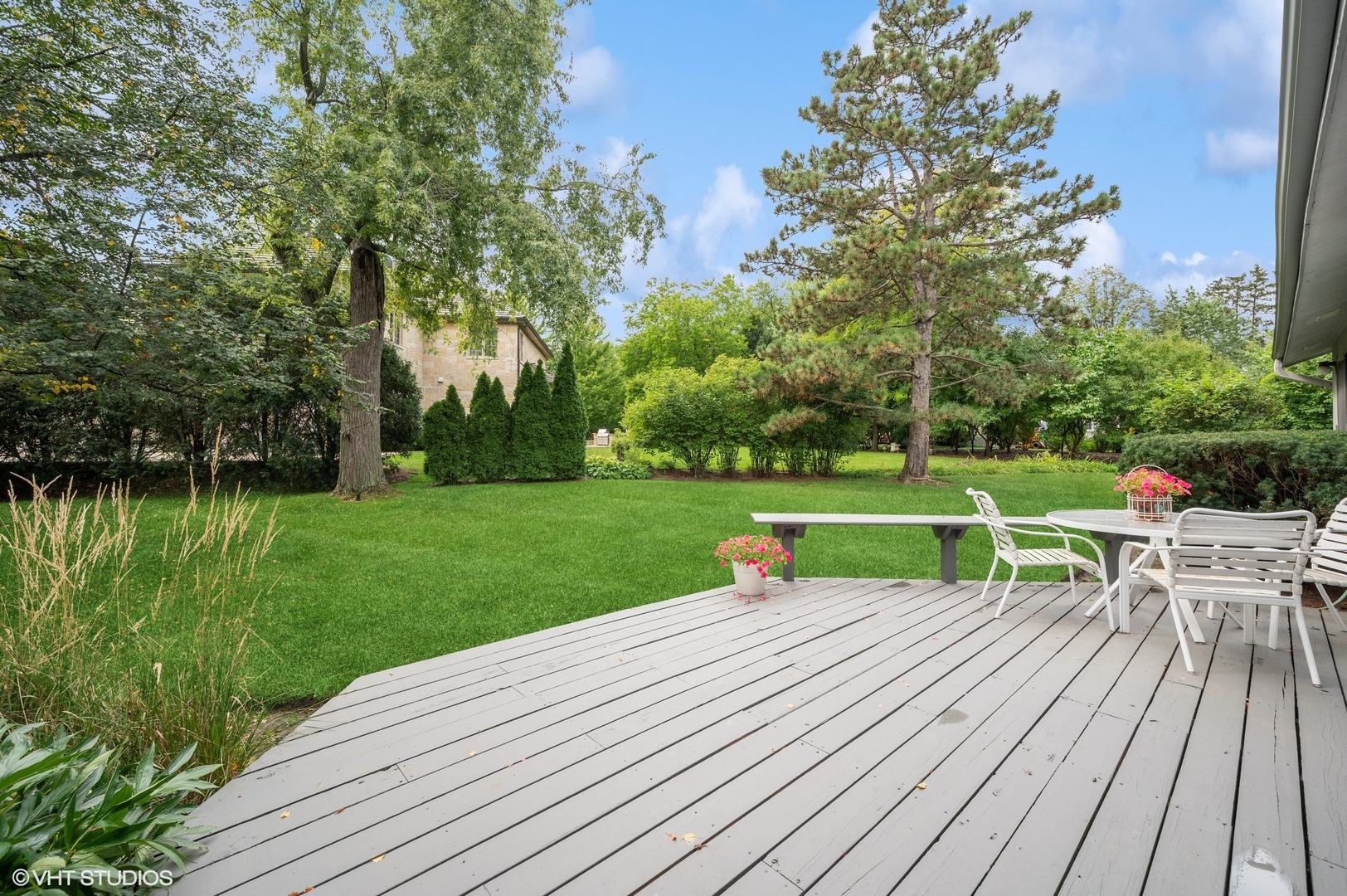 63 Overlook Drive Golf, IL 60029 - Photo 27 of 32 a view of a table and chairs on the wooden deck