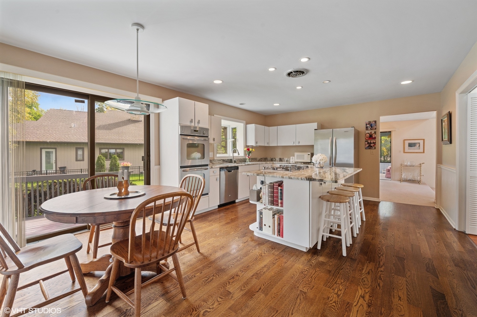 63 Overlook Drive Golf, IL 60029 - Photo 9 of 32 a view of a dining room and livingroom with furniture wooden floor a chandelier