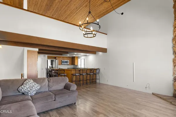 a kitchen with stainless steel appliances a dining table chairs and granite counter tops