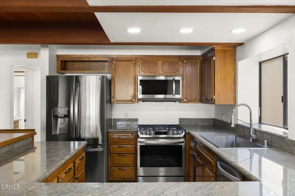 a kitchen with a sink cabinets and window