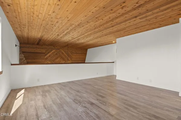 an empty room with wooden floor and a window