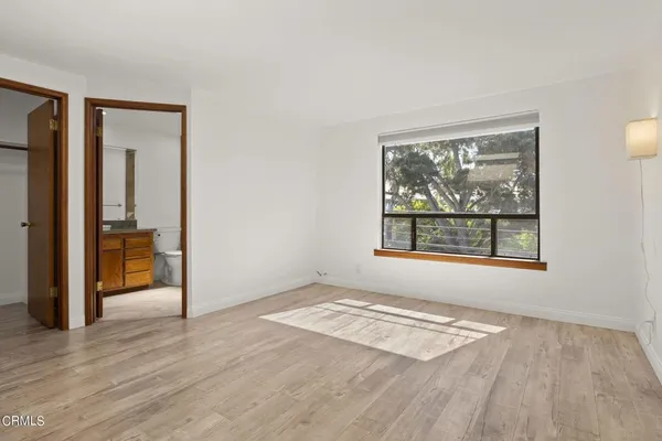 a spacious bedroom with a bed and a view of bathroom