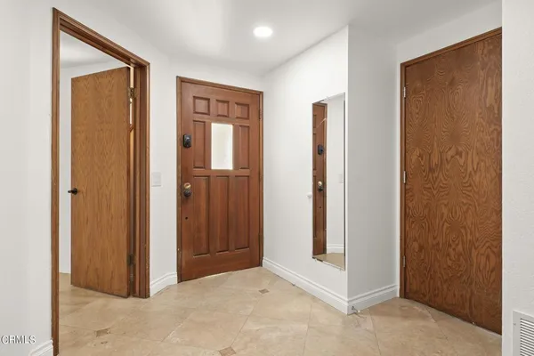 an empty room with windows and closet