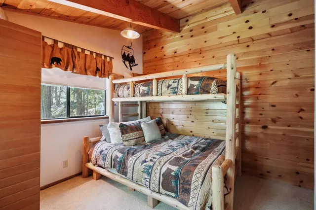 a bed sitting in a bedroom next to a window