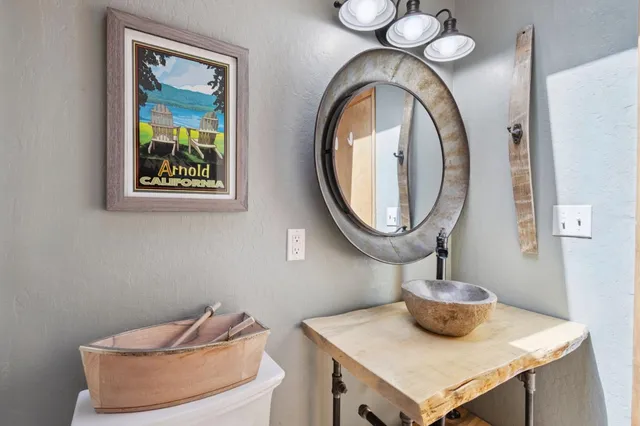 a bathroom with a toilet a sink and a mirror