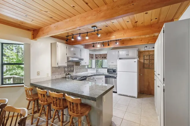 a kitchen with refrigerator and cabinets