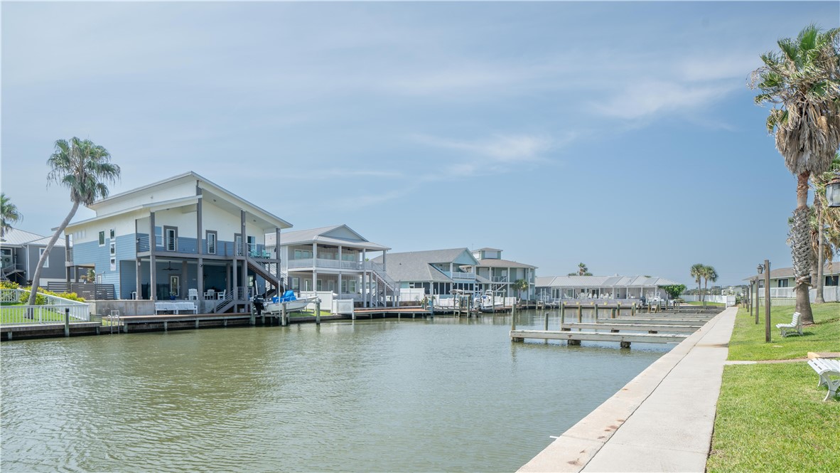 2290 North Fulton Beach Road Rockport, TX 78382 - Photo 6 of 26 a view of a house next to a lake with a large building