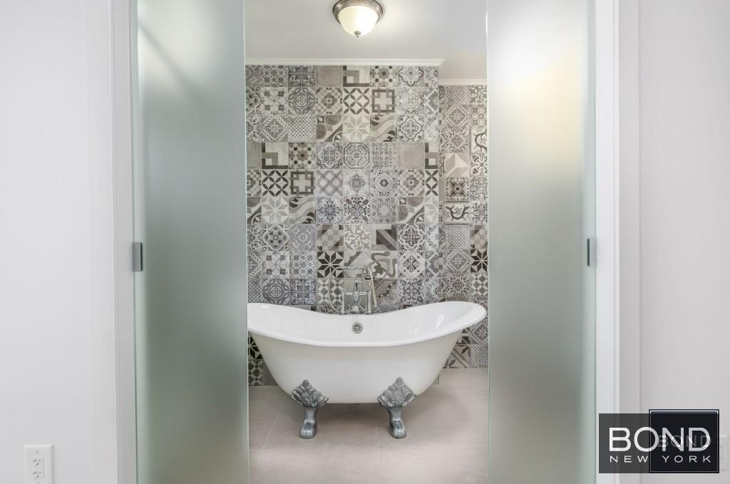 11-49 Welling Court, Unit 3 Queens, NY 11102 - Photo 6 of 8 a bathroom with a sink toilet and shower