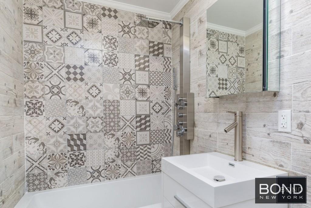 11-49 Welling Court, Unit 3 Queens, NY 11102 - Photo 8 of 8 a bathroom with a sink and a bathtub