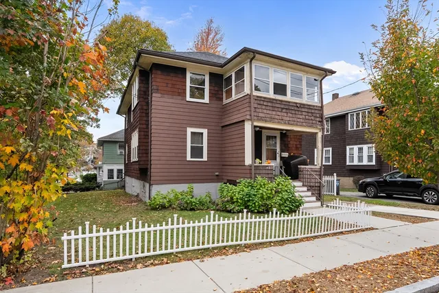 a front view of a house with a garden