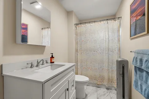 a bathroom with a sink toilet and shower