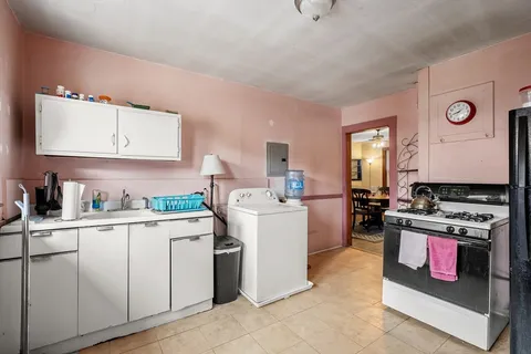 a kitchen with a stove top oven and cabinets