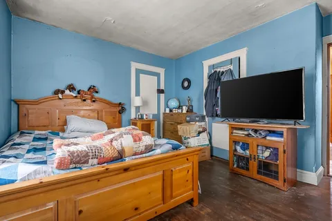 a bedroom with furniture and a flat screen tv