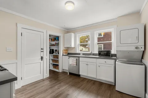 a kitchen with granite countertop a refrigerator and a sink