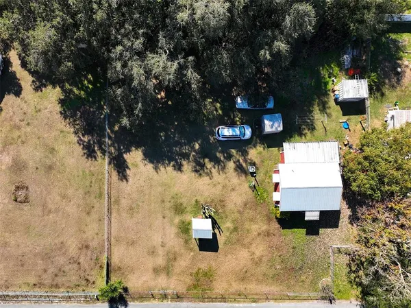 an aerial view of a house with a yard