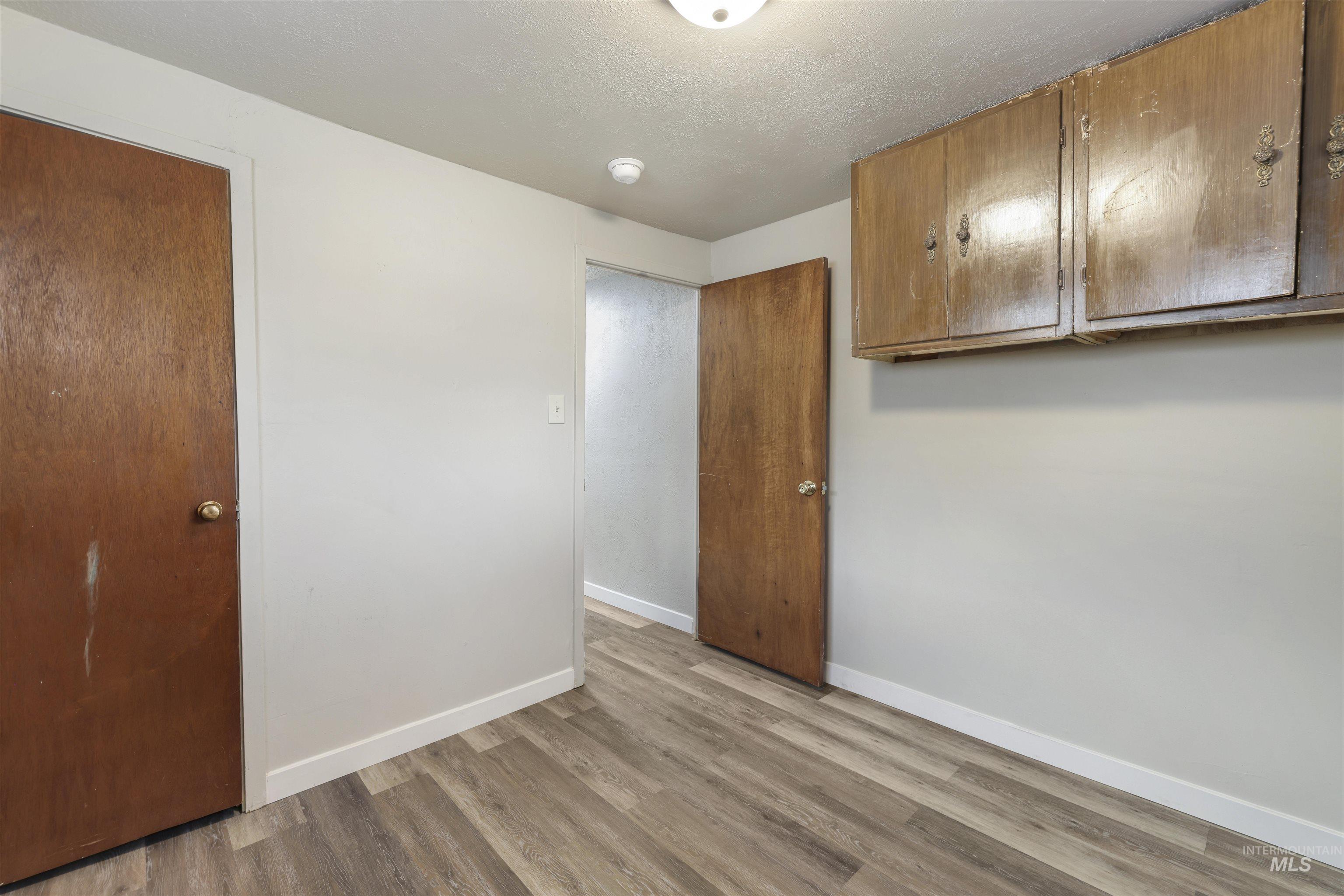 545 Madison Street Twin Falls, ID 83301 - Photo 14 of 23 Unfurnished bedroom featuring a textured ceiling and light wood-type flooring