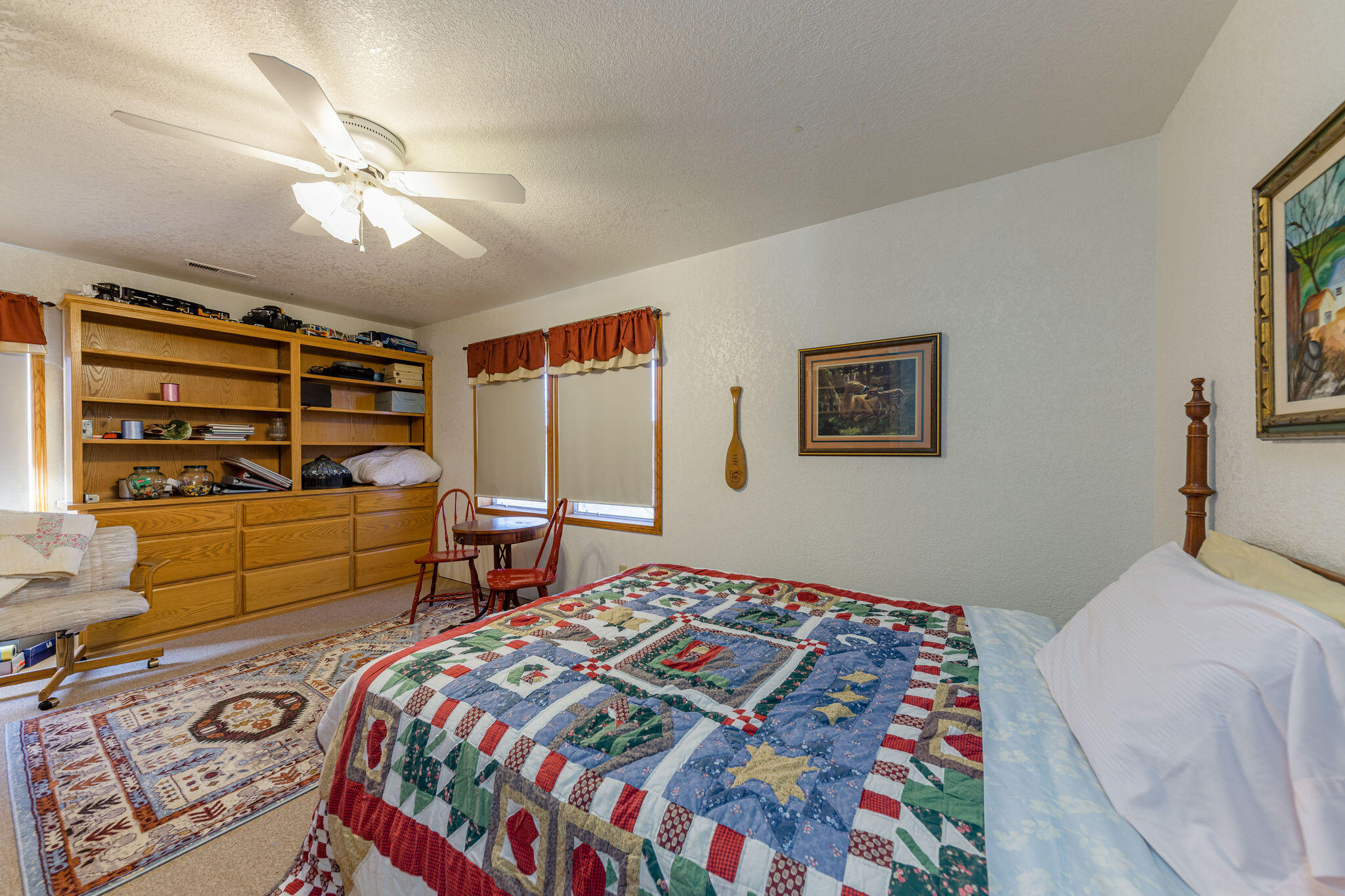 6790 Holland Loop Road Cave Junction, OR 97523 - Photo 28 of 151 a bedroom with a bed and a dresser