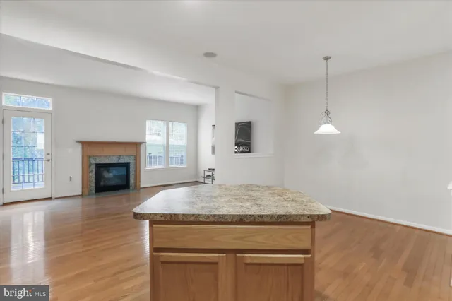 a kitchen with a stove and a wooden floor