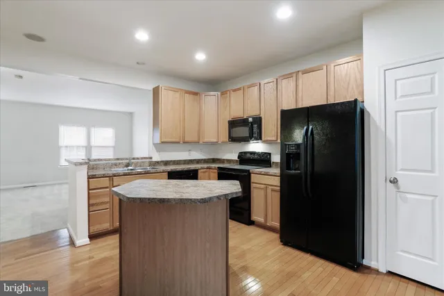 a kitchen with a refrigerator stove and sink