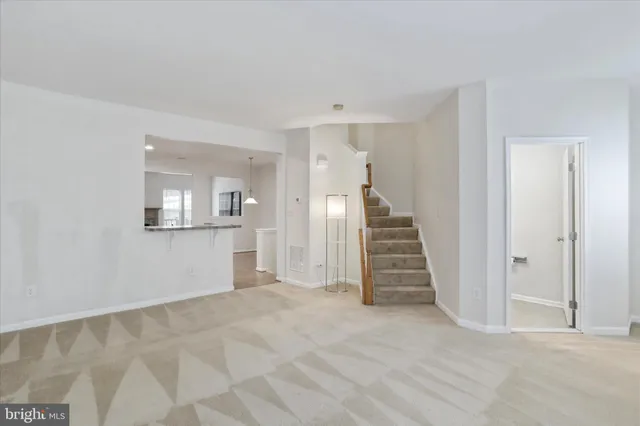 a view of a hallway with wooden floor and entryway