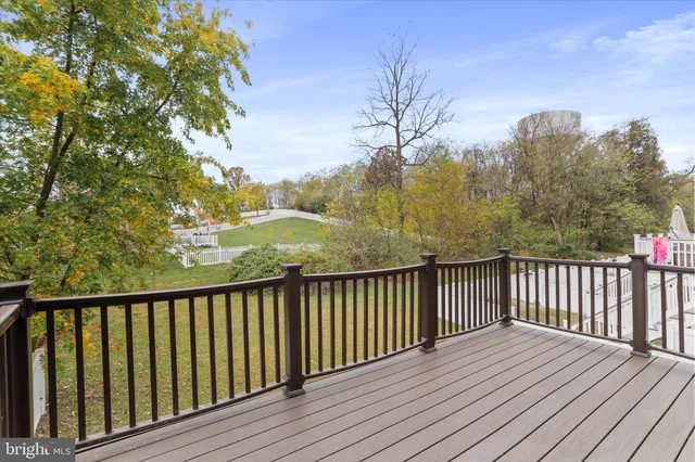 a view of balcony with wooden floor and fence