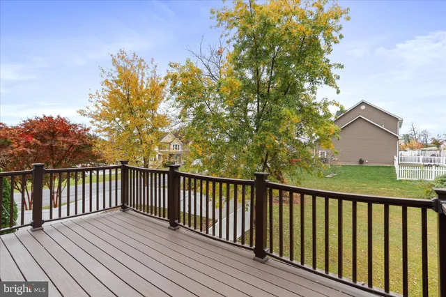 a balcony with wooden floor and fence