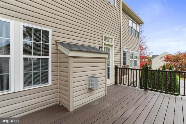 a view of a balcony with wooden floor and fence