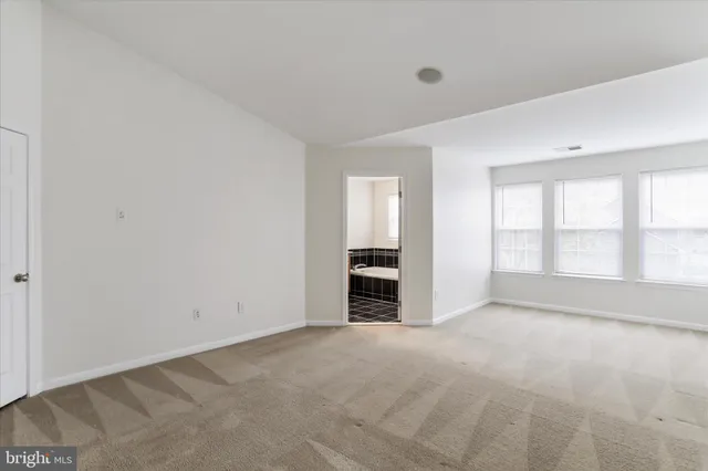 a kitchen with granite countertop a stove top oven a refrigerator and a fireplace