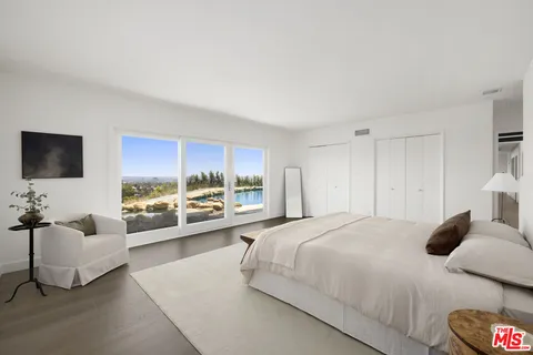 a bedroom with a bed and a couch